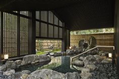 the inside of a building with rocks and water