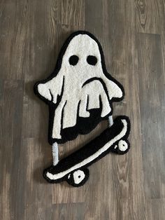 a black and white rug with a ghost riding a skateboard on top of it