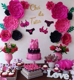 a table topped with lots of cakes and cupcakes