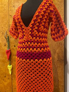 a crocheted dress is displayed on a mannequin