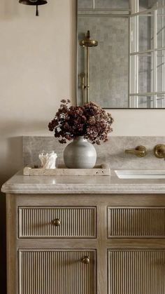 a bathroom vanity with marble top and drawers