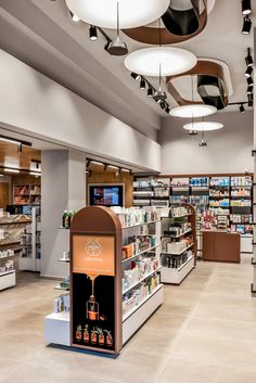 the inside of a store with many items on shelves and lights hanging from the ceiling