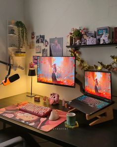 two computer monitors sitting on top of a desk next to a keyboard and monitor screen