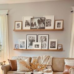 a living room filled with lots of furniture and pictures on the wall above it's coffee table