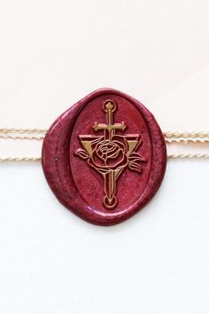 a wax seal with a cross and rose on it