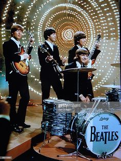 the beatles on stage with their instruments