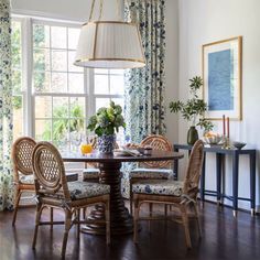 a dining room table with four chairs around it