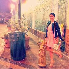 a woman is standing next to a fire hydrant