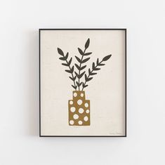 a painting with dots and leaves in a vase on the wall above it is a black frame