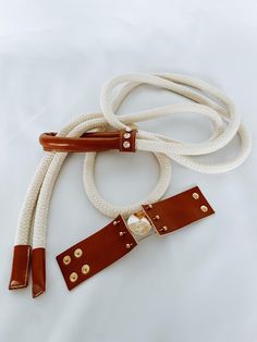 Discover the perfect addition to your summer wardrobe - Rope Belt. This elegant rope combined with leather blends style and practicality in the best possible way. Made from high-quality cotton and durable leather, it is the ideal choice for a chic look. Whether you're taking a relaxed stroll through the city or embarking on an adventurous journey, the rope belt will be a reliable companion. Its exceptional combination of materials ensures comfort, durability, and resilience, while its elegant de Rope Belt, Suspender Belt, Cotton Rope, Look Chic, Slovenia, Suspenders, Summer Wardrobe, Cognac, Elegant Design