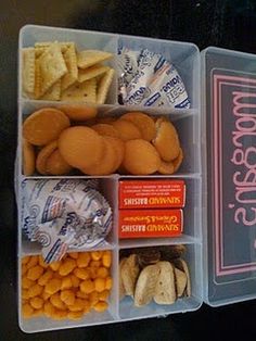 a plastic container filled with different types of snacks and condiments on top of a table