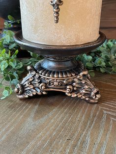 a white candle sitting on top of a wooden table