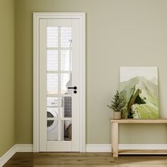 an empty room with a bench and painting on the wall next to a white door