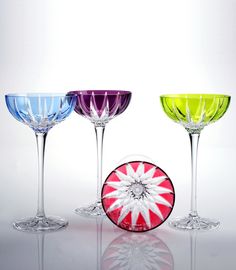 three wine glasses with different colors and designs