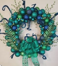 a green wreath with blue and green ornaments