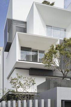 an apartment building with balconies on the top floor