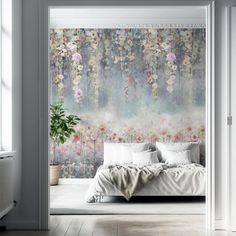 a bedroom scene with focus on the bed and wallpaper that has flowers all over it