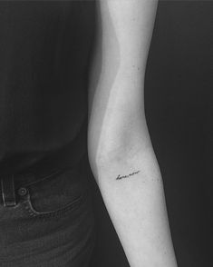 a woman's arm with a small tattoo that reads, i love you on it