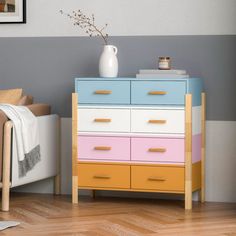 a bedroom with a bed, dresser and pictures on the wall