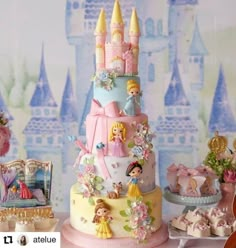 there is a cake with princesses on it and other decorations around the cake table