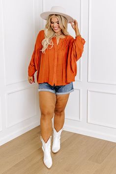 You and this darling plus size rust colored shift top were made for each other with its lightweight material, a button up front with a rounded neckline, long loose sleeves with tie closure cuffs, and a relaxed silhouette that falls into a straight hemline! Measurements 1XL : Bust 62", Hip 56", Length 25", Sleeve Length 23", Waist 60". 2XL : Bust 64", Hip 58", Length 25.5", Sleeve Length 23", Waist 62". 3XL : Bust 66", Hip 60", Length 26", Sleeve Length 24", Waist 64". Fall Orange Blouse With Button Closure, Rust Color, Model Fits, Women Clothing Boutique, Hip Length, Online Womens Clothing, Boutique Clothing, Length Sleeve, Button Up