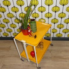 a yellow table with some plants on it