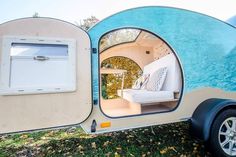 the inside of an rv with its door open and couch in it's side