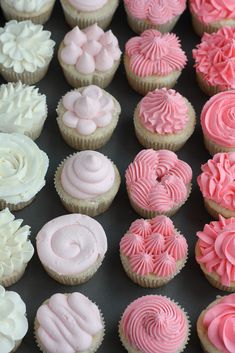 a tray filled with cupcakes on top of a wooden table