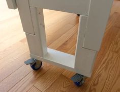 a close up of a small cart on the floor with wood floors in the background