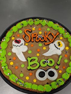 a decorated halloween cake with spooky boo on it