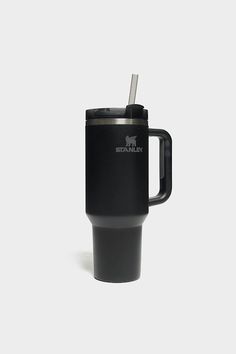 a black travel mug with a straw in it