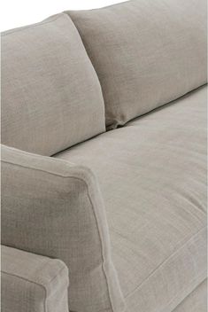 the back end of a couch with two pillows on it's armrests