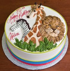 the birthday cake is decorated with an image of two zebras and a giraffe