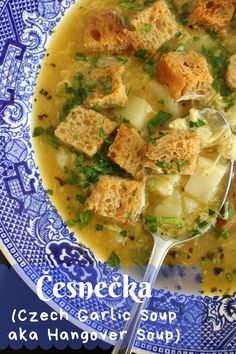 a blue and white plate topped with soup