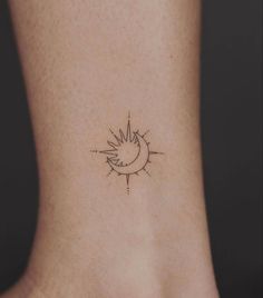 a small sun and moon tattoo on the back of a woman's foot,