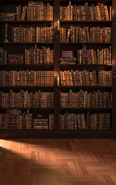 a book shelf filled with lots of books on top of wooden flooring next to a window