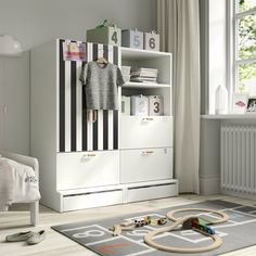 a child's room with toys, bookshelf and dresser in the corner