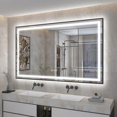 a bathroom with two sinks and a large mirror over the sink that has lights on it