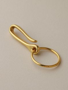 a pair of gold colored scissors on a white surface