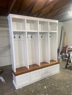 a room filled with lots of white cabinets and wooden shelves on top of each other