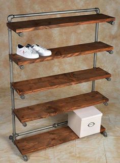 three tiered shelving unit with two pairs of shoes on top and one shoe box below