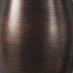 a brown vase sitting on top of a wooden table