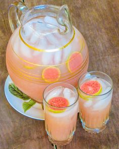 a pitcher and two glasses filled with watermelon