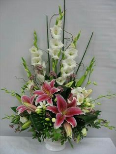 a vase filled with white and pink flowers