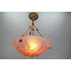 an orange glass bowl hanging from the ceiling