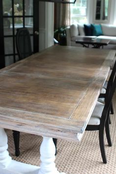 a wooden table sitting in the middle of a living room