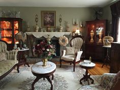 a living room filled with furniture and a fire place in the middle of a room