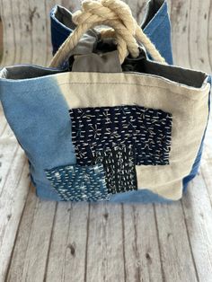 a blue and white bag sitting on top of a wooden table