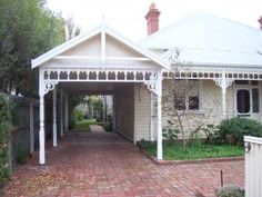 a white house with a brick walkway leading to it