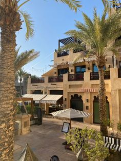 an outside view of a hotel with palm trees